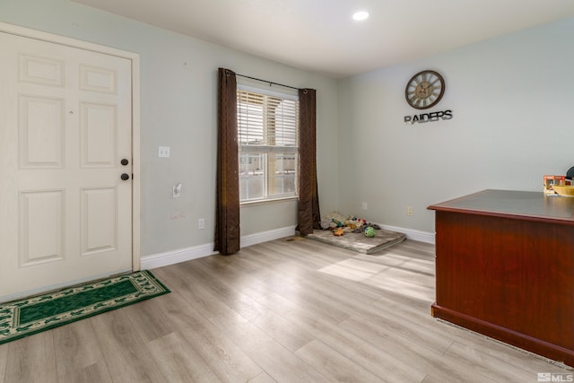 foyer entrance with light hardwood / wood-style floors