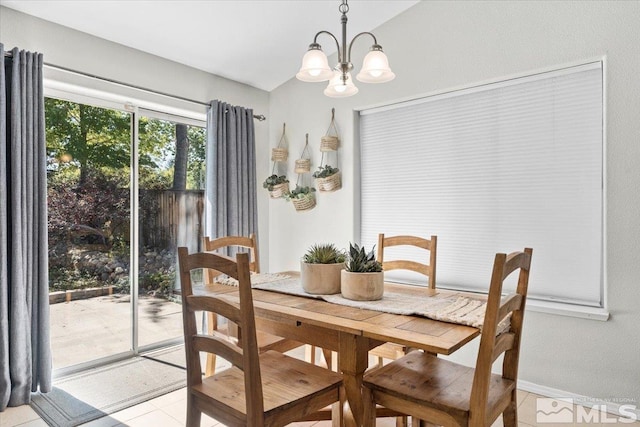 tiled dining room featuring a chandelier