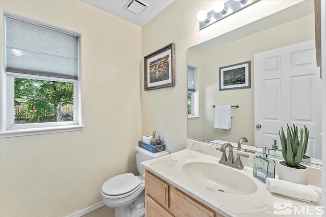 bathroom featuring vanity and toilet