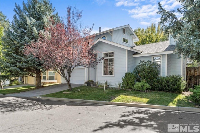 view of front facade with a garage and a front yard