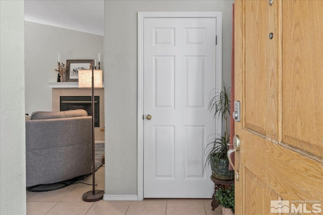 tiled entryway with vaulted ceiling