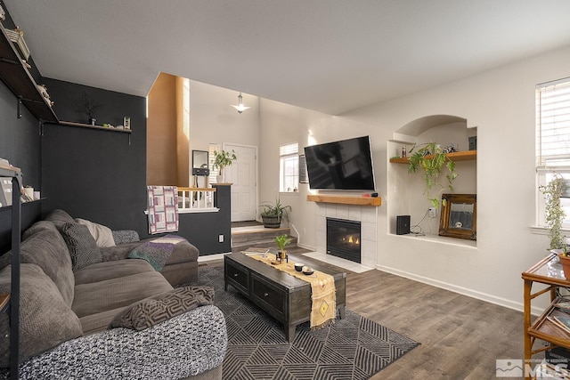 living room featuring dark hardwood / wood-style floors and a tile fireplace