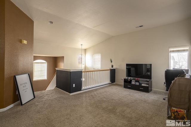 carpeted living room featuring vaulted ceiling