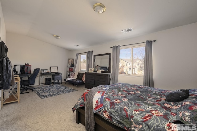 carpeted bedroom with lofted ceiling