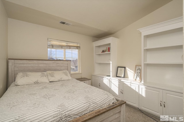 bedroom with light carpet and lofted ceiling