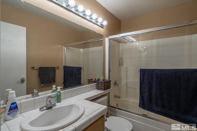 full bathroom featuring vanity, enclosed tub / shower combo, and toilet