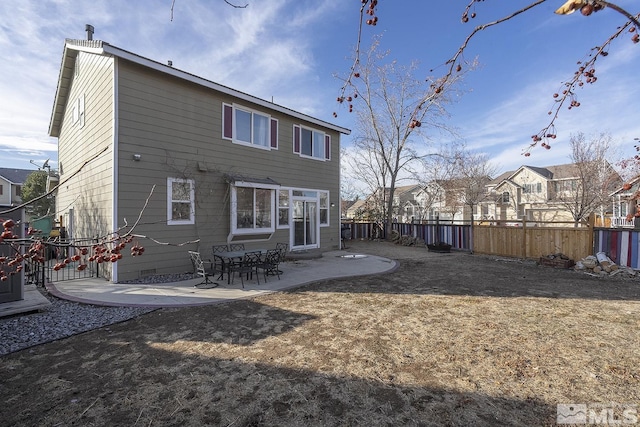 back of property with a patio