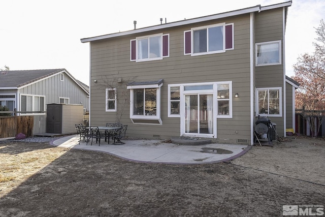 rear view of property featuring a patio area and a storage shed