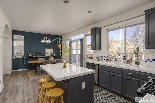 kitchen featuring pendant lighting, a healthy amount of sunlight, sink, and appliances with stainless steel finishes