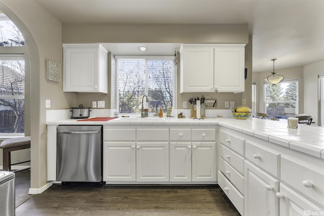 kitchen with white cabinetry, sink, dark wood-type flooring, tile countertops, and pendant lighting