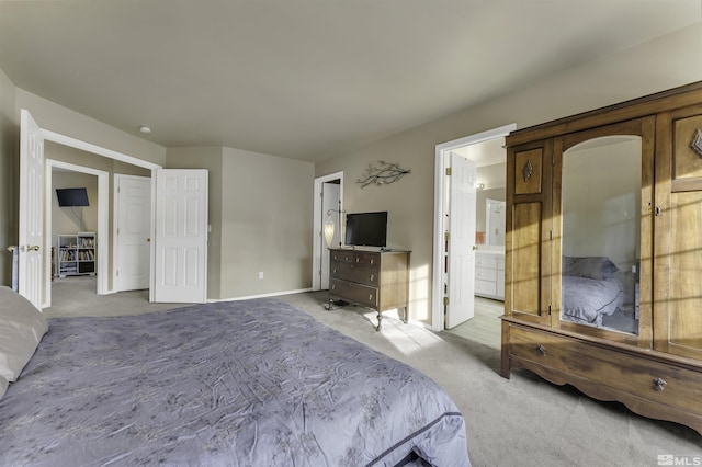 unfurnished bedroom featuring light carpet and ensuite bath