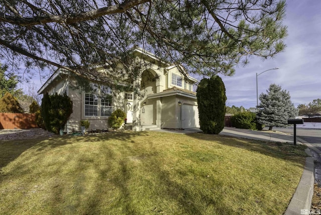 view of front of home with a front yard and a garage