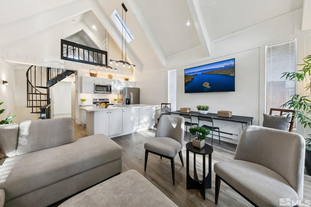 living room featuring beamed ceiling, hardwood / wood-style flooring, and high vaulted ceiling