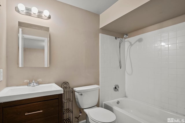 full bathroom with vanity, tiled shower / bath combo, and toilet