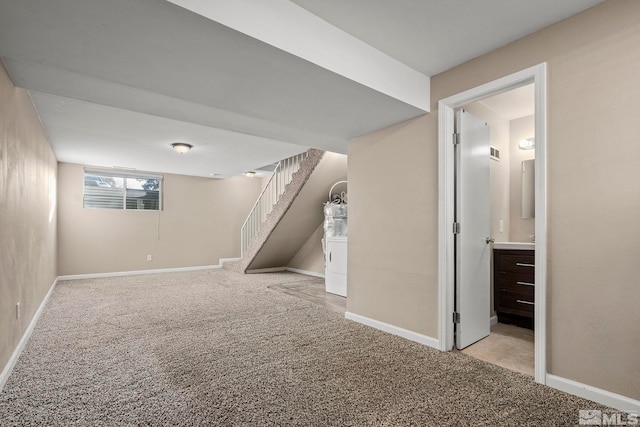 basement featuring light carpet