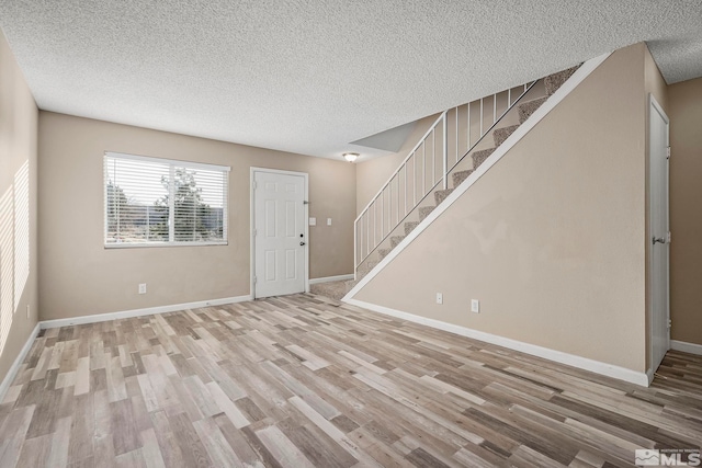 interior space with light hardwood / wood-style flooring and a textured ceiling