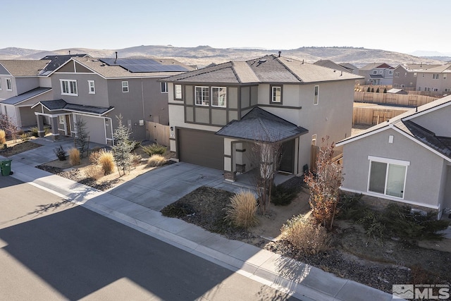 view of front of property featuring a mountain view and a garage