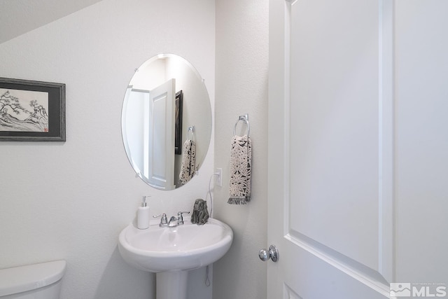 bathroom featuring sink and toilet