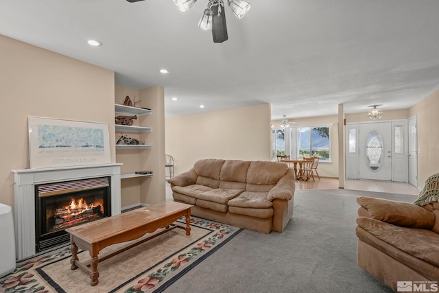 living room with ceiling fan and light carpet