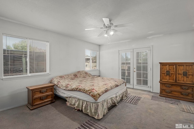 carpeted bedroom with ceiling fan, access to exterior, a textured ceiling, and french doors