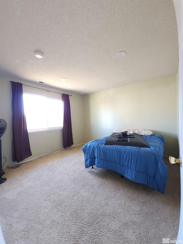 carpeted bedroom with a textured ceiling