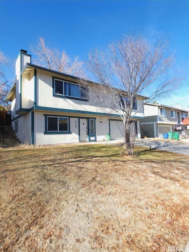 view of front of home with a garage and a front yard