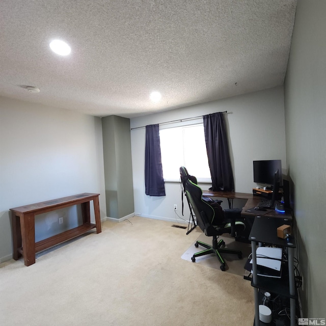 office space with a textured ceiling and carpet floors