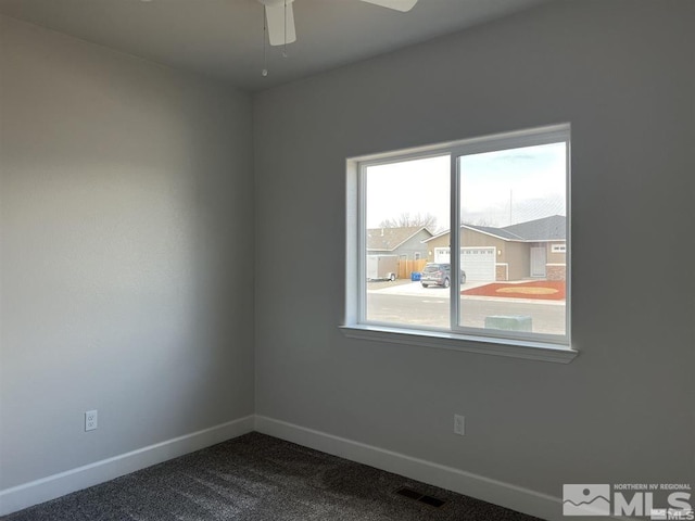 unfurnished room featuring ceiling fan and carpet floors