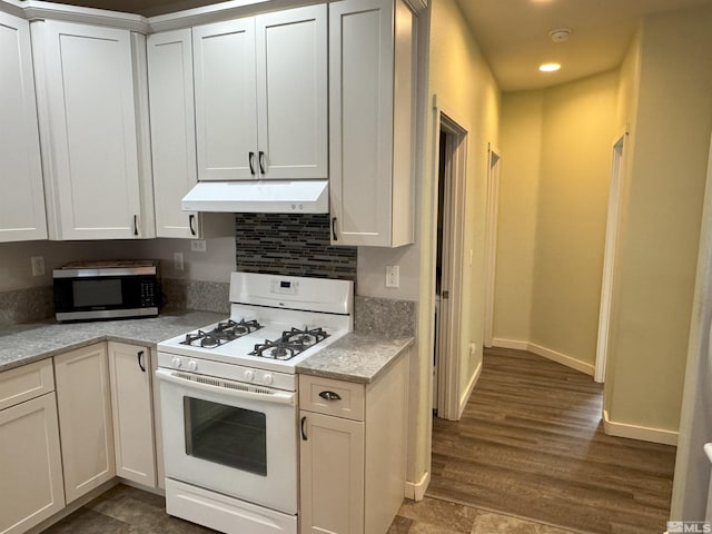 kitchen with white cabinets, decorative backsplash, dark hardwood / wood-style flooring, and gas range gas stove