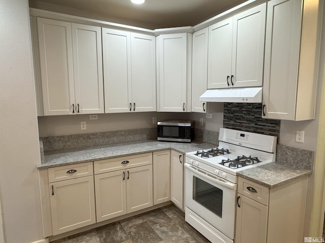 kitchen featuring light stone counters and white gas range oven