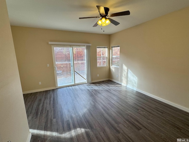 spare room with ceiling fan and dark wood-type flooring