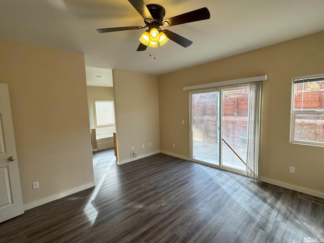 spare room featuring dark hardwood / wood-style flooring and ceiling fan