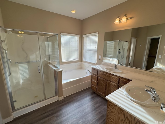 bathroom with independent shower and bath, vanity, and wood-type flooring