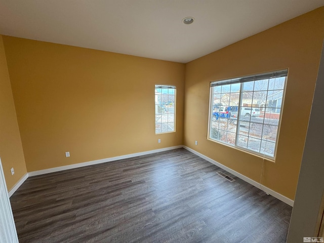 empty room with dark wood-type flooring