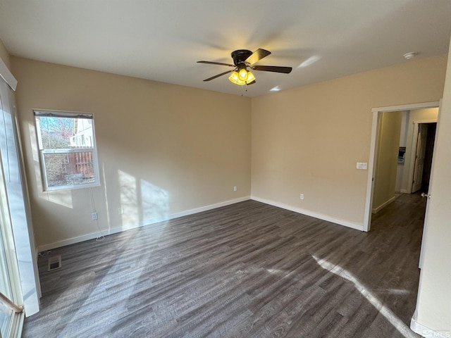 empty room featuring dark hardwood / wood-style flooring and ceiling fan