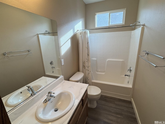 full bathroom with hardwood / wood-style floors, vanity, shower / bath combo, and toilet