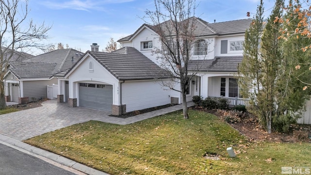 view of front of home featuring a garage and a front lawn