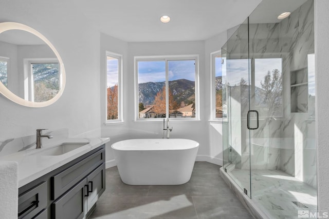 bathroom featuring vanity and shower with separate bathtub