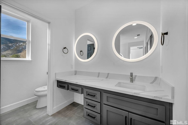 bathroom featuring vanity and toilet