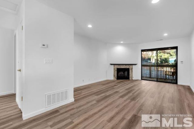 unfurnished living room featuring light hardwood / wood-style floors