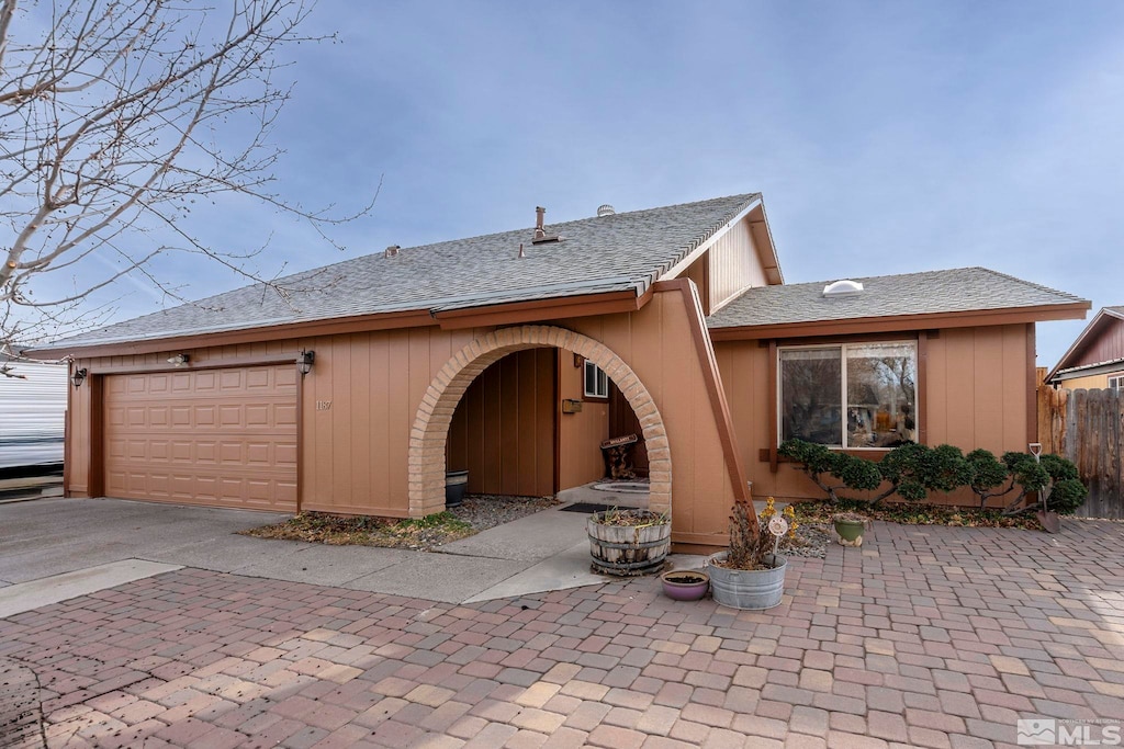 rear view of property with a garage