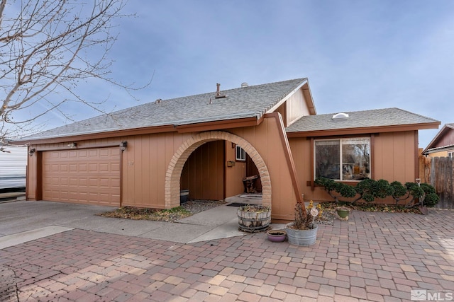 rear view of property with a garage