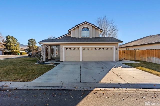 view of front property featuring a garage and a front lawn