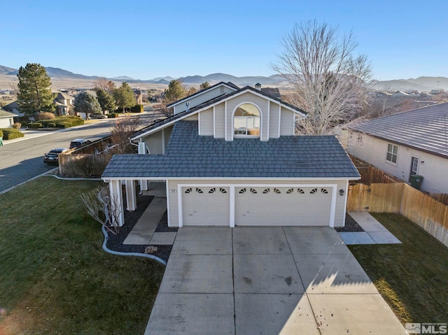 view of property with a mountain view, a garage, and a front lawn