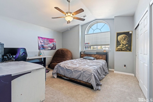 carpeted bedroom featuring ceiling fan, a closet, and vaulted ceiling