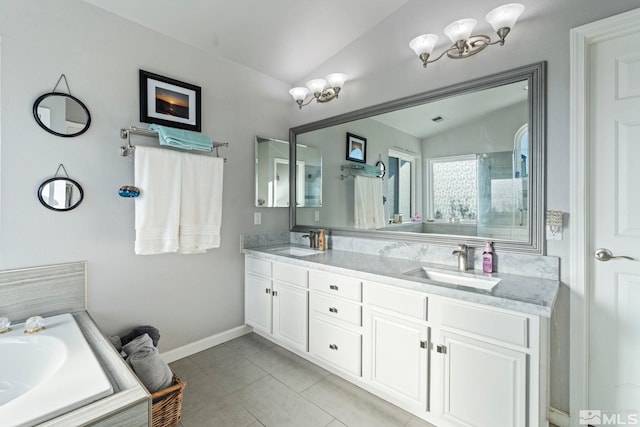 bathroom with tile patterned flooring, vanity, and lofted ceiling