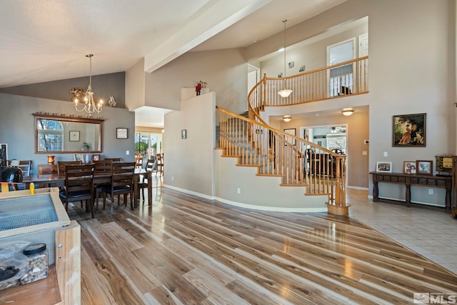 interior space with a chandelier, high vaulted ceiling, and wood-type flooring