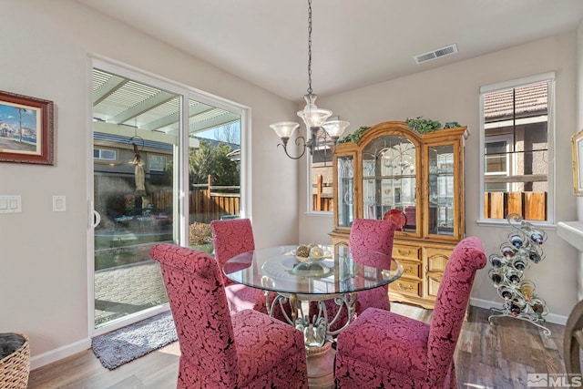 dining room featuring light hardwood / wood-style floors and a notable chandelier