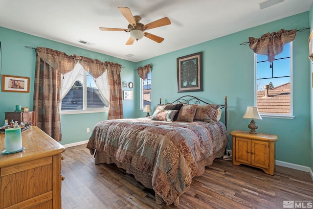 bedroom with ceiling fan and dark wood-type flooring