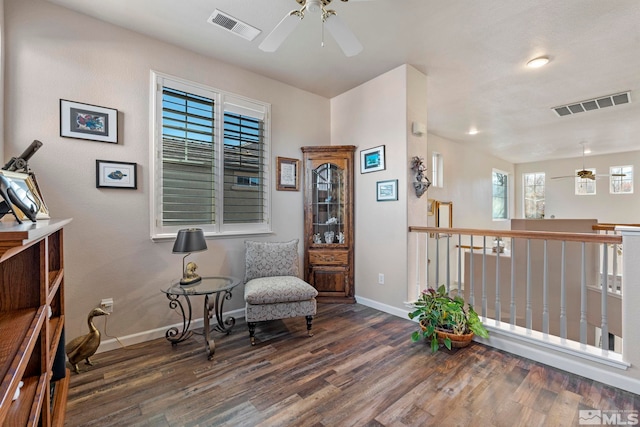 sitting room featuring ceiling fan and dark wood-type flooring